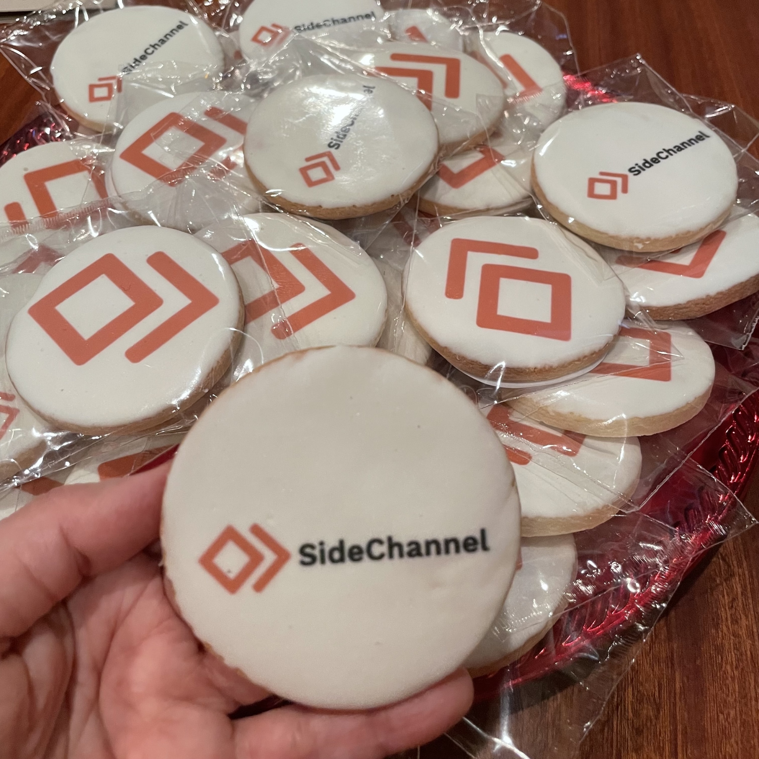 White sugar cookies feature red SideChannel logo