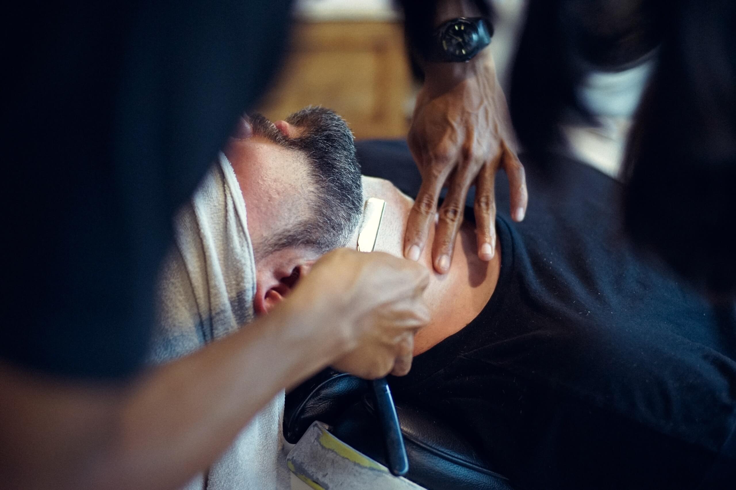 Man getting a shave at a barber shop