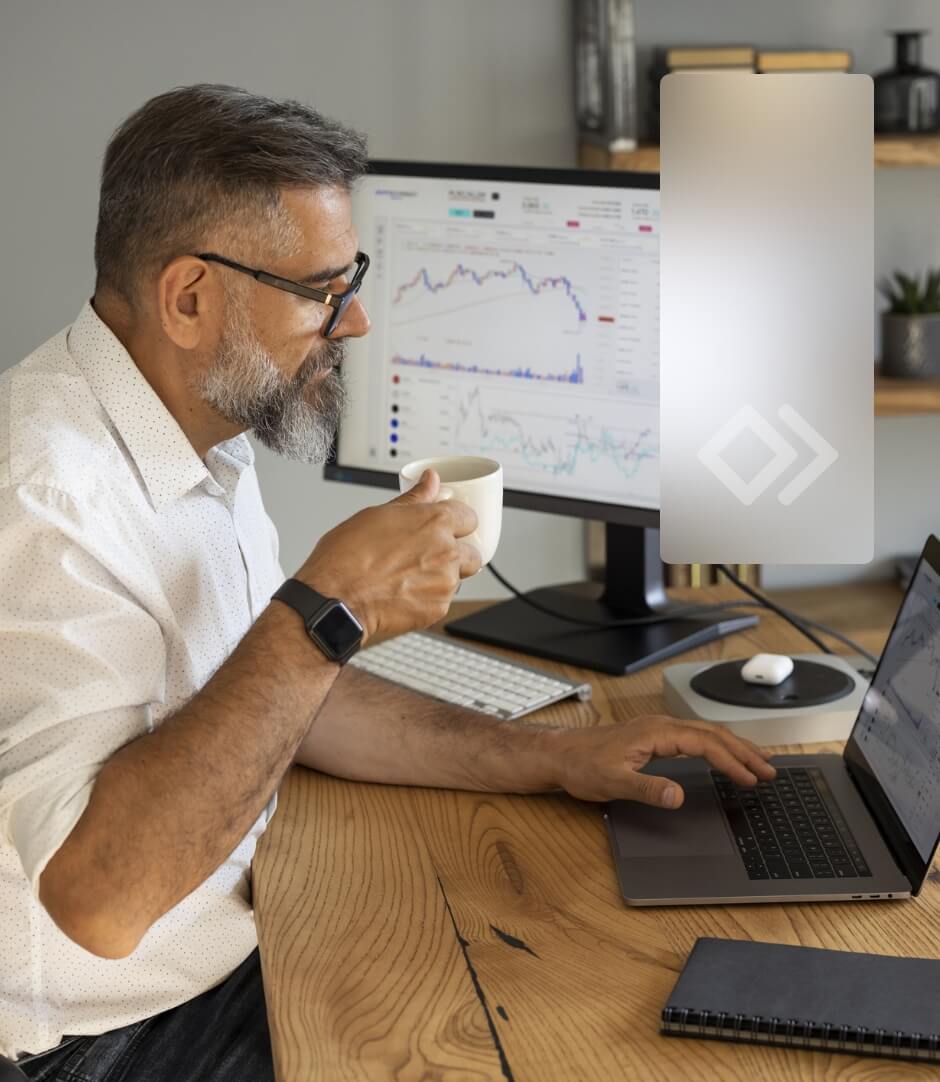 A man with glasses working on his computer.