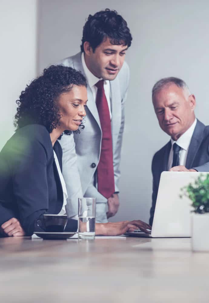 Three People In Front Of a Laptop